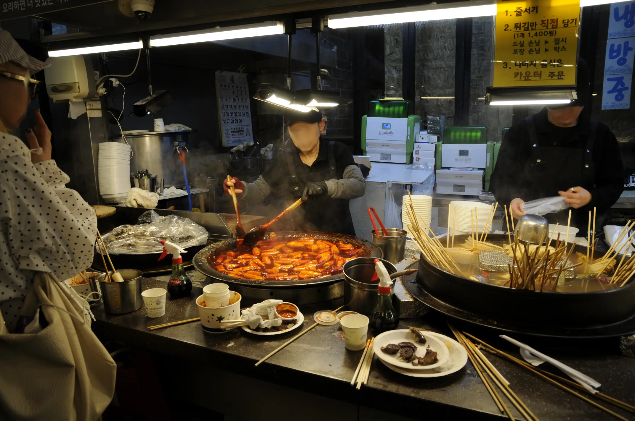 Food stand vendor stirring tteobokki in Haeundae Traditional Market